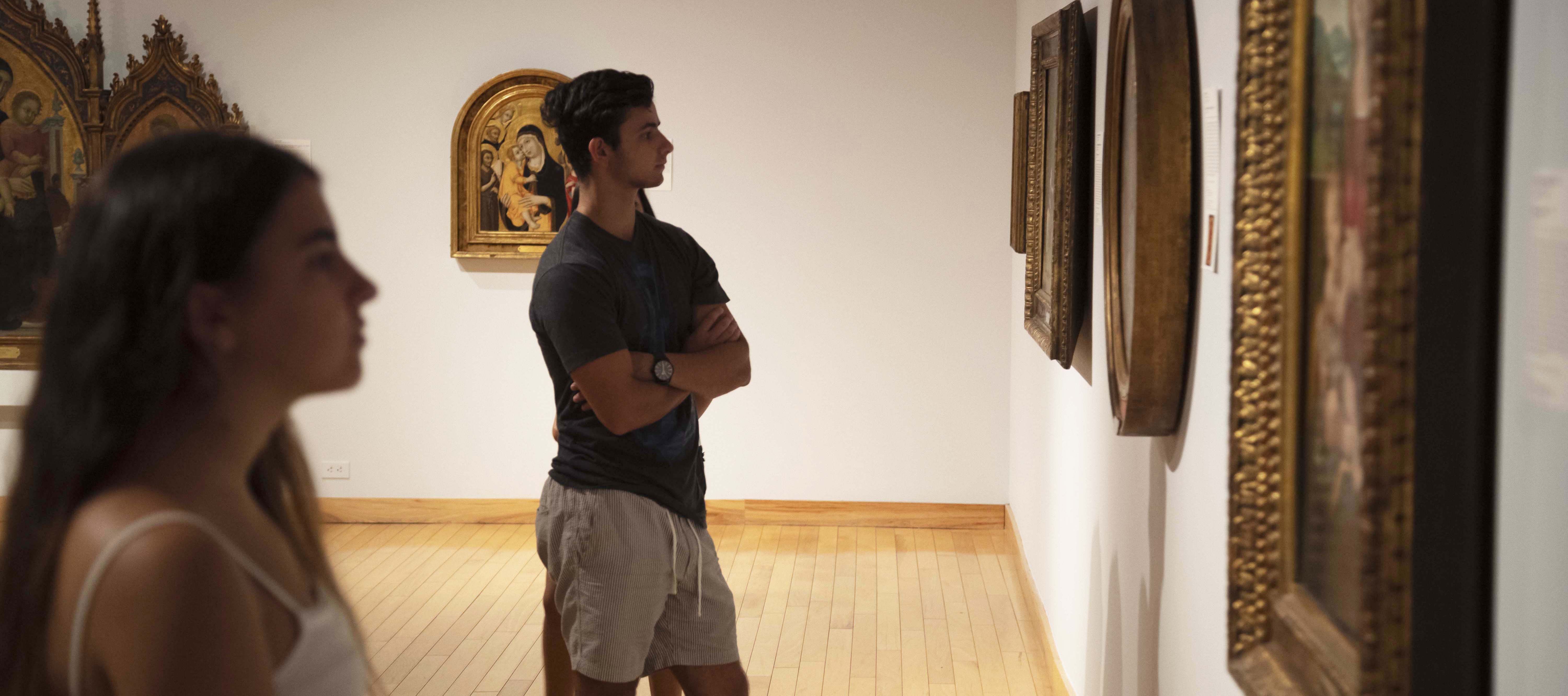 college students looking at paintings