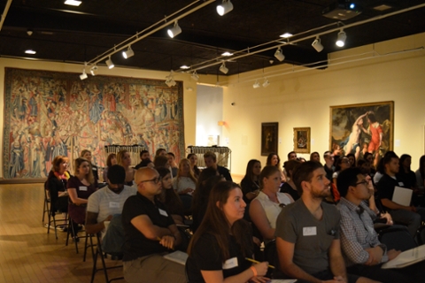 image of people seated in galleries listening to lecture