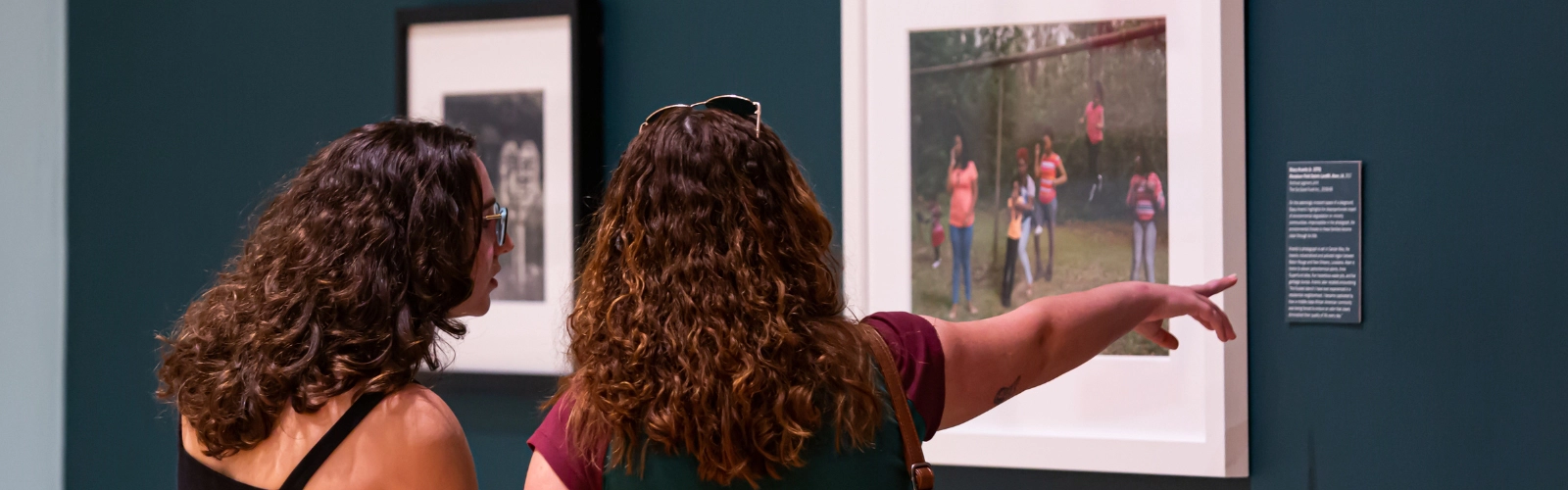 Students looking at a photo at the Lowe art museum