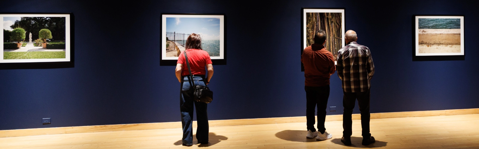 Guest looking at a photo at the Lowe art museum