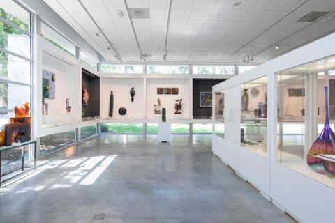 photo of the palley pavillion with installed artworks made of class. Open room with cement floor, windows placed low and high with a lot of natural ligtht, some work free standing, some work in glass cases.