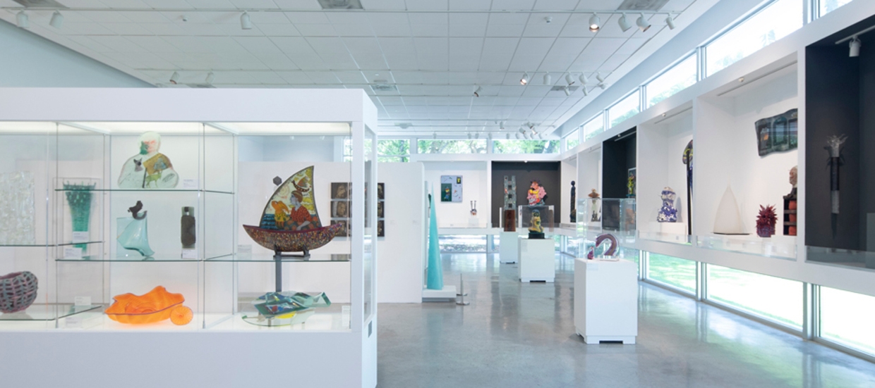 photo of the palley pavillion with installed artworks made of class. Open room with cement floor, windows placed low and high with a lot of natural ligtht, some work free standing, some work in glass cases.