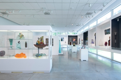 photo of the palley pavillion with installed artworks made of class. Open room with cement floor, windows placed low and high with a lot of natural ligtht, some work free standing, some work in glass cases.