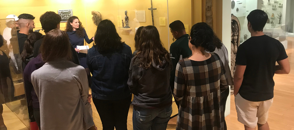 image of college students being spoken to in a gallery of African Art