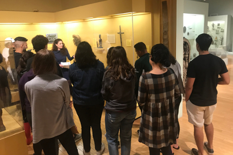 image of college students being spoken to in a gallery of African Art