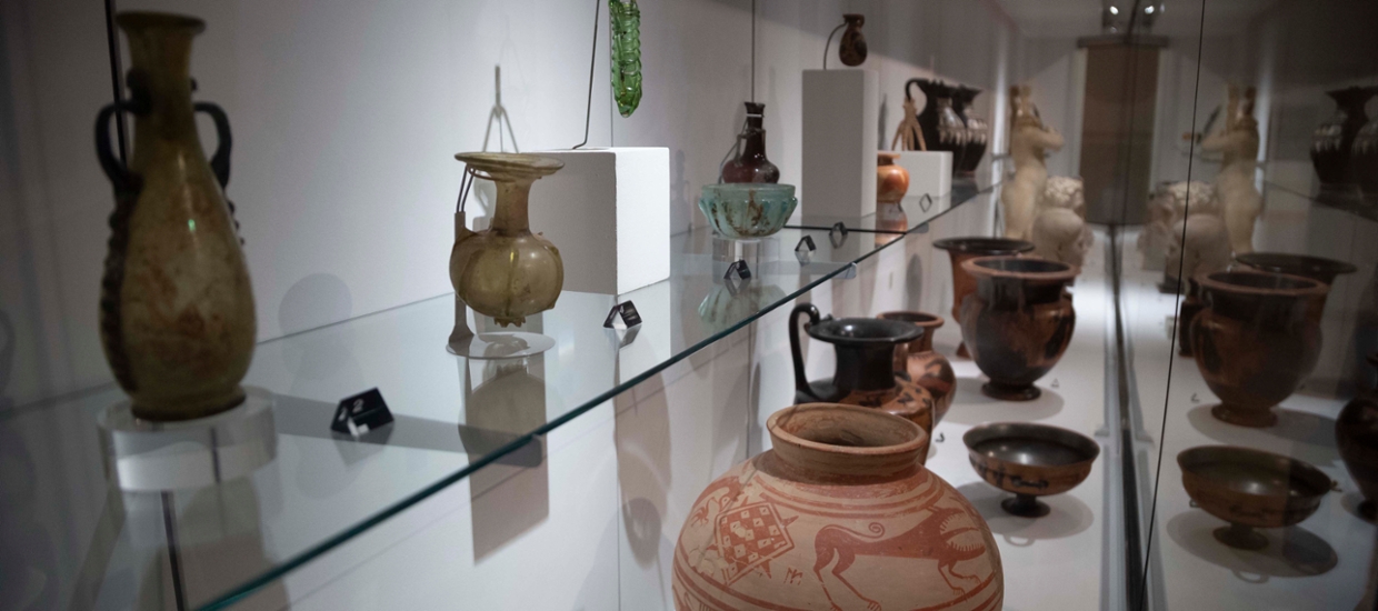 image of ancient Greek and Roman vases in a glass case