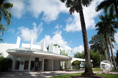 image depicting the fron exterior of the Lowe with abstract sculpture and palm trees in the foreground