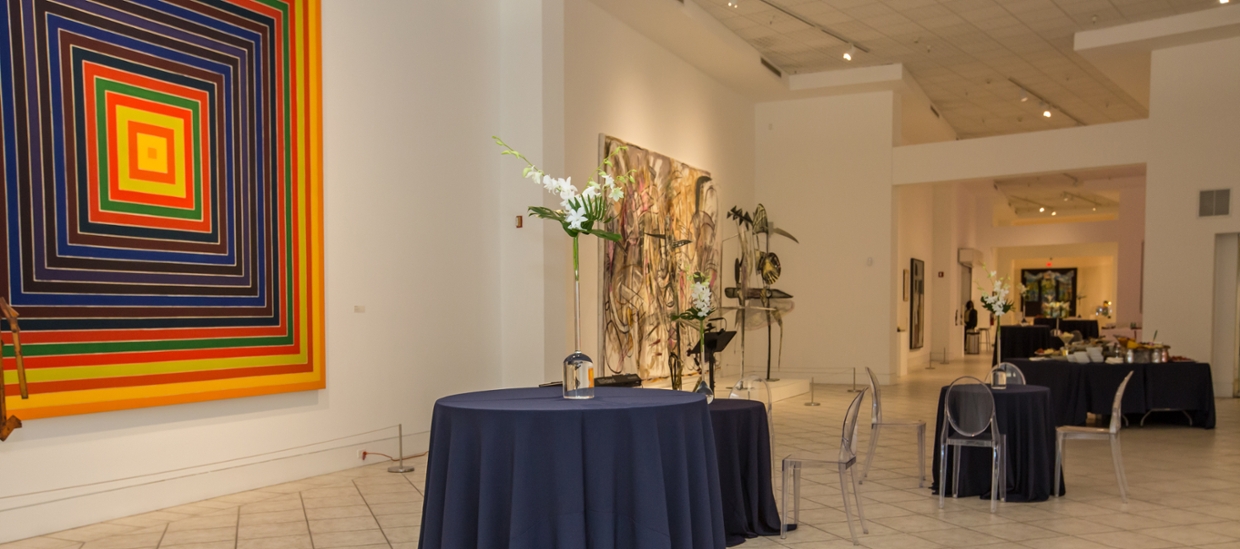picture of tobin gallery set up for a facility rental with talbes with blue table cloths