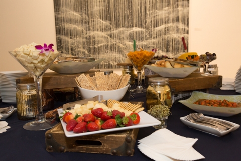 image of catered food on plates set up for a facility rental. Strawberries, cheese and crackers