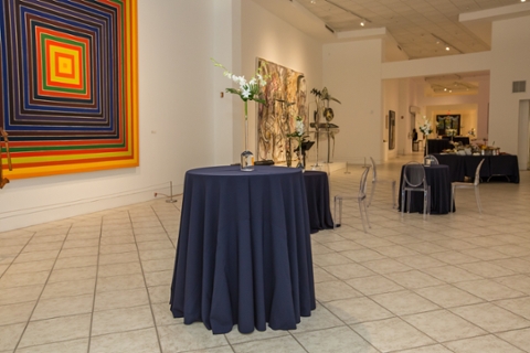 picture of tobin gallery set up for a facility rental with talbes with blue table cloths
