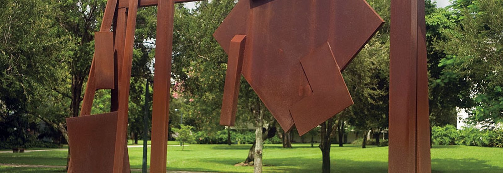 abstract large scale metal sculpture comprised of geometric shapes rust color