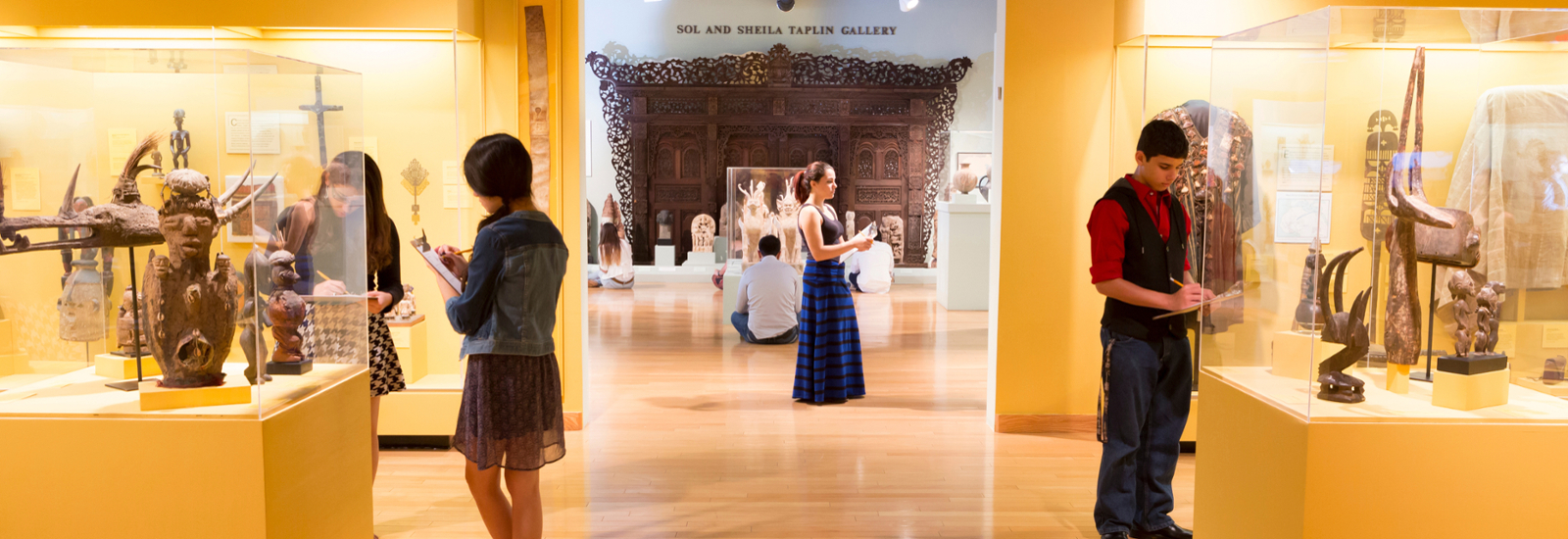 students standing in gallery with clipboards and pencils in hand