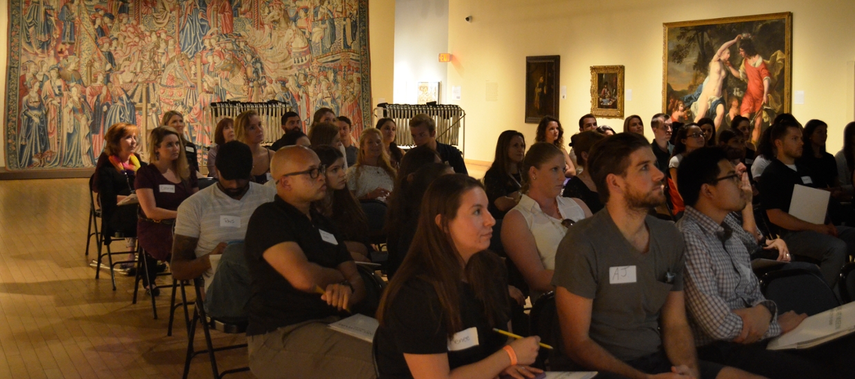 image of people in galleries listening to a lecture