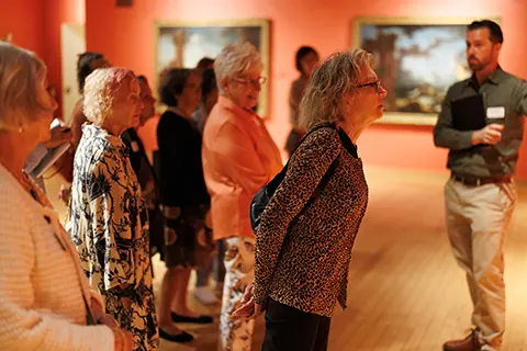 People taking a tour of the Lowe with a Volunteer