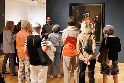 People taking a tour of the Lowe with a Volunteer